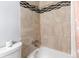 Bathroom featuring beige tile, shower, and bathtub at 983 S Joplin Way, Aurora, CO 80017