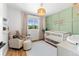 Bedroom featuring a comfy armchair, crib, and soft color palette at 983 S Joplin Way, Aurora, CO 80017