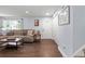 Living room with L-shaped sofa, wood floors, and large window at 983 S Joplin Way, Aurora, CO 80017