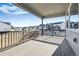 Covered deck overlooking the neighborhood with wood railings at 5672 Red Pebble Pt, Castle Rock, CO 80104