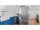 Kitchen corner with blue cabinets, stainless steel refrigerator, and wood-style flooring at 3700 S Bannock St, Englewood, CO 80110