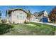 Ranch-style home with stone accents, two-car garage, and grassy yard at 13505 W 86Th Dr, Arvada, CO 80005