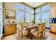 Kitchen dining area with a rustic wooden table and striped chairs at 13505 W 86Th Dr, Arvada, CO 80005