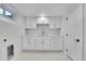 Bright, spacious laundry room with white cabinets and a utility sink at 975 S Fillmore Way, Denver, CO 80209