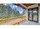 Covered balcony with scenic views of trees and landscape at 11790 Huckleberry Dr, Franktown, CO 80116