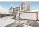 Gray two-story house with a white garage and snowy front yard at 18971 E Mercer Dr, Aurora, CO 80013