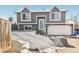 Two-story house with gray siding, a blue door, and a snowy yard at 18971 E Mercer Dr, Aurora, CO 80013