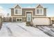 Two-story house, gray siding, attached garage, and snowy front yard at 18971 E Mercer Dr, Aurora, CO 80013