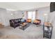 Living room with leather couches, coffee table, and view of the dining area at 18971 E Mercer Dr, Aurora, CO 80013