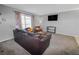 Living room with dark leather sofas, a coffee table, and a TV at 18971 E Mercer Dr, Aurora, CO 80013