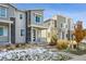 Two-story townhome with gray and beige siding, welcoming front porch at 18040 E 96Th Pl, Commerce City, CO 80022