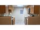 Galley kitchen with wood cabinets and tile floors at 14453 E Jewell Ave # 103, Aurora, CO 80012