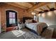 Spacious bedroom with exposed brick and wood beams, featuring a plush bed and ample closet space at 1792 Wynkoop St # 502, Denver, CO 80202