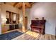 Living room with hardwood floors, exposed beams, and antique piano at 1792 Wynkoop St # 502, Denver, CO 80202
