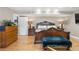 Main bedroom with hardwood floors, large bed, and dresser at 1945 Yarrow St, Lakewood, CO 80214