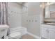 Clean bathroom with tile surround and granite vanity at 1945 Yarrow St, Lakewood, CO 80214