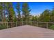 Spacious deck with scenic wooded views and modern cable railing at 7 Elk Pointe Ln, Castle Rock, CO 80108