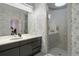 Modern bathroom with double sinks, a large shower, and marble walls at 7 Elk Pointe Ln, Castle Rock, CO 80108