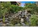 Serene waterfall feature with pond, creating a tranquil outdoor space at 7 Elk Pointe Ln, Castle Rock, CO 80108