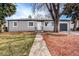 Ranch style home with landscaped yard and attached garage at 3092 S Kearney St, Denver, CO 80222