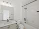 Modern bathroom with white subway tiles, a bathtub, and gray vanity at 2048 S Holly St # 1, Denver, CO 80222