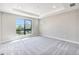 Bright bedroom with carpeted floor and large window at 2048 S Holly St # 1, Denver, CO 80222