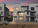 Modern three-story townhome with gray and white exterior, and balcony at 2048 S Holly St # 1, Denver, CO 80222