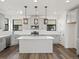 Modern kitchen with gray cabinets, quartz countertops, and an island at 2048 S Holly St # 1, Denver, CO 80222