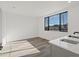 Bright and airy living room with large window and wood-look floors at 2048 S Holly St # 1, Denver, CO 80222