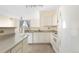 White kitchen with stainless steel appliances and laminate floors at 1760 Morrison Ct, Superior, CO 80027