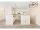 White kitchen with laminate floors and breakfast bar at 1760 Morrison Ct, Superior, CO 80027