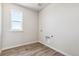 Bright laundry room features vinyl flooring and built-in shelving at 3362 N Highlands Creek Pkwy, Aurora, CO 80019