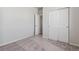 Carpeted bedroom with neutral walls, single door closet, and access to another room at 3362 N Highlands Creek Pkwy, Aurora, CO 80019