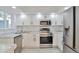 Updated kitchen featuring white shaker cabinets and stainless steel appliances at 862 N Uvalda St, Aurora, CO 80011