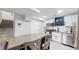 Modern basement kitchen with white cabinets and stainless steel appliances at 6996 Warren Dr, Denver, CO 80221