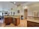 Open kitchen with island, granite counters, and stainless steel appliances at 6678 S Shawnee Ct, Aurora, CO 80016