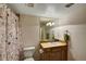 Clean bathroom with shower/tub combo, vanity with sink, and updated fixtures at 6678 S Shawnee Ct, Aurora, CO 80016