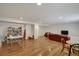 Finished basement with hardwood floors, ample space for recreation, and built-in shelving at 6678 S Shawnee Ct, Aurora, CO 80016