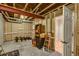 Unfinished basement area with exposed beams, offering great storage potential at 6678 S Shawnee Ct, Aurora, CO 80016
