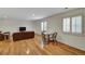 Finished basement with hardwood floors, comfortable seating area and a dining table at 6678 S Shawnee Ct, Aurora, CO 80016
