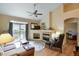 Spacious living room with hardwood floors, fireplace, and patio access at 6678 S Shawnee Ct, Aurora, CO 80016