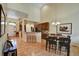 Dining area with hardwood floors and view into kitchen and living room at 6678 S Shawnee Ct, Aurora, CO 80016