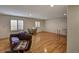 Finished basement recreation area featuring hardwood floors and a large window at 6678 S Shawnee Ct, Aurora, CO 80016