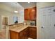 Small kitchenette with granite countertops and wood cabinets at 6678 S Shawnee Ct, Aurora, CO 80016