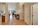 Hardwood floor hallway with view into living room and access to other rooms at 6678 S Shawnee Ct, Aurora, CO 80016