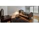 Charming bedroom with hardwood floors, a quaint bed and a writing desk at 6678 S Shawnee Ct, Aurora, CO 80016