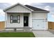 Charming house with white siding and black accents at 944 Savona Ave, Fort Lupton, CO 80621