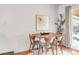 Charming dining area with a mid-century modern table and four chairs at 909 Nelson St, Lakewood, CO 80215