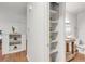 Bathroom with a floating vanity, toilet, and built-in shelving at 909 Nelson St, Lakewood, CO 80215