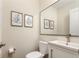 Small bathroom with white vanity, toilet and a modern mirror at 1025 Collyer St, Longmont, CO 80501